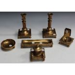 An early 20th Century gilt cast bronze desk set, comprising a pair of candlesticks, both marked '