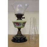 A late Victorian opalescent and floral painted glass oil lamp with shaped vaseline glass shade, on a