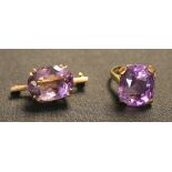 An 18ct gold and amethyst single stone ring, claw set with a large cushion shaped amethyst, and a