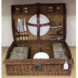 An Edwardian wicker cased picnic set by Drew & Sons, Piccadilly Circus, the interior fitted with