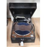 A Columbia portable gramophone within a black case, together with a collection of accessories,