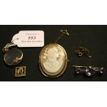 A gold mounted circular pendant locket, detailed '9ct', a gold and seed pearl set ribbon slide,