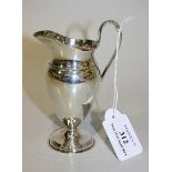 A late Victorian silver cream jug, the ovoid body with loop handle, on a circular foot, London