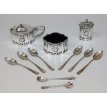 A silver three piece condiment set of oval lobed form with pierced floral motifs, comprising