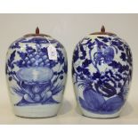 A near pair of Chinese blue and white porcelain jars with wood covers, late 19th/early 20th Century,