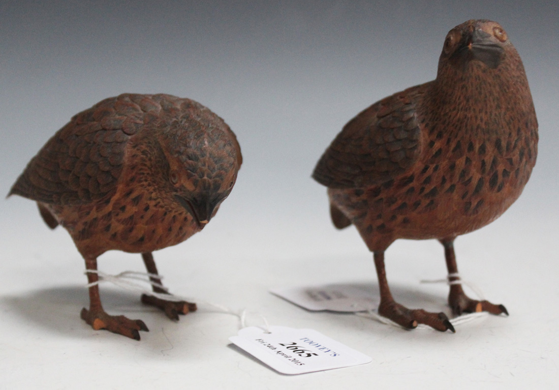 A pair of 20th Century Black Forest carved softwood models of quail with finely carved and