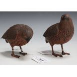 A pair of 20th Century Black Forest carved softwood models of quail with finely carved and