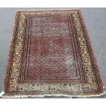 A Serrabend rug, North-west Persia, early 20th Century, the red field with overall offset rows of