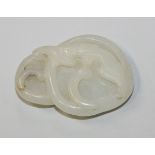 A Chinese white jade pendant, Qing dynasty, carved in the form of a bat laying upon two mushrooms,