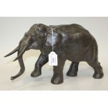 A Japanese brown patinated cast bronze figure of an elephant, Meiji/Taisho period, modelled standing