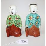 A pair of Chinese famille rose export porcelain figures, Jiaqing period, each boy modelled kneeling,