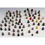 A collection of thimbles, including approximately nineteen sterling silver examples.