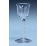 An engraved double series opaque twist stem wine glass, late 18th Century, the ogee bowl engraved