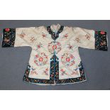 A Chinese cream silk embroidered short jacket, early 20th Century, worked in coloured threads with