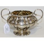 A George IV silver two handled sugar bowl of lobed baluster form, on a flared foot, London 1829 by