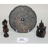 A Chinese bronze mirror, one side cast with birds, animals and foliage, diameter approx 14cm,