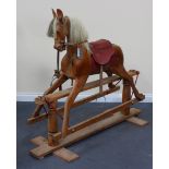 A 20th Century pine rocking horse with leather fittings and pine stand, height approx 131cm,