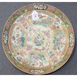 A Chinese Canton famille rose medallion saucer dish, mid-19th Century, the interior painted with