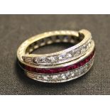 A gold, synthetic ruby, synthetic sapphire and colourless gem set swing over and under eternity