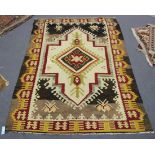 A Turkish kelhim rug, early 20th Century, the ivory field with a hooked medallion, within a claret