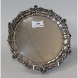 An Edwardian silver card salver with 'C' scroll and scallop shell rim, on scroll legs, Sheffield