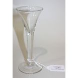 A wine glass, mid-18th Century, the drawn trumpet bowl raised on a plain stem and conical foot,