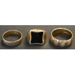 Two 9ct gold decorated wedding rings, and a 9ct gold and rectangular black onyx set signet ring.