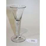 A wine glass, mid-18th Century, the drawn funnel bowl raised on a teared plain stem and conical