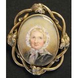 A Victorian portrait miniature brooch, glazed with the portrait of a lady wearing a blue and white