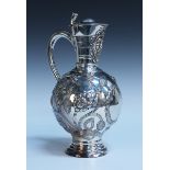 An Edwardian silver claret jug with a tappit lid and grotesque mask spout, the globular body