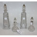 A pair of cut glass scent bottles and stoppers with silver collars (marks worn), and a pair of glass