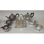 A Walker & Hall plated six bottle cruet stand, the wirework frame containing six cut glass