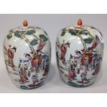 A pair of Chinese famille rose porcelain jars and covers, late 19th/early 20th Century, each painted