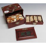 A 20th Century Mah Jong set with bamboo and bone tiles, within a metal mounted hardwood box with