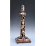 An early Victorian banded agate and white metal mounted model of a lighthouse, the column with an