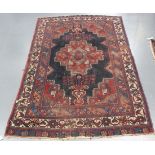 A Shirvan rug, South-east Caucasus, early 20th Century, the blue field with a shaped medallion and