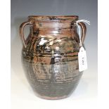 A studio pottery three handled vase, 20th Century, the ovoid body with indistinct incised detail