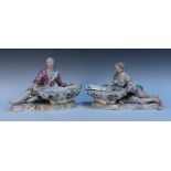 A large pair of Meissen porcelain figural salts, late 19th Century, modelled as a reclining male and