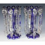 A pair of blue flash overlay clear glass table lustres, 20th Century, each hung with cut glass spear