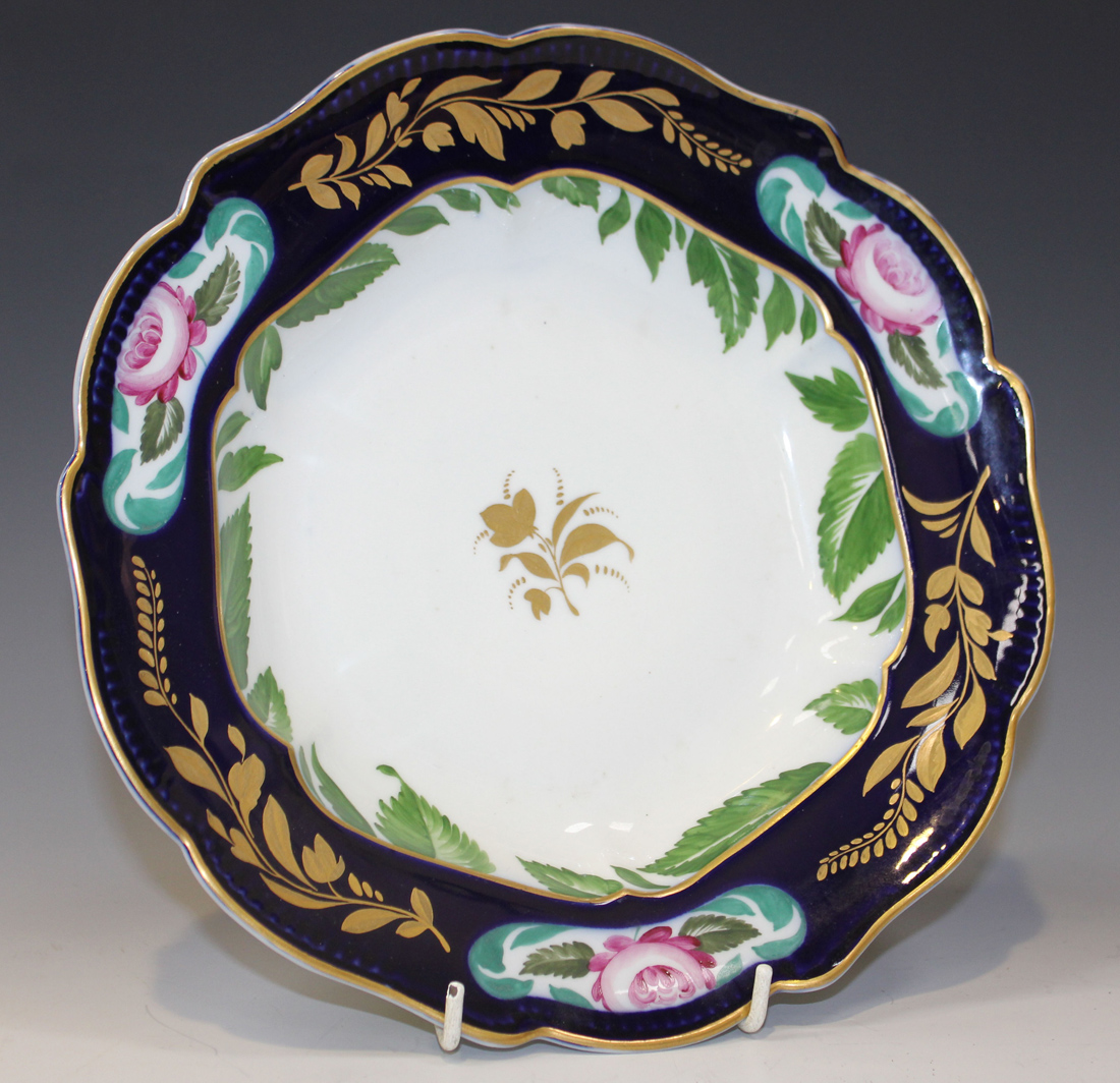 A Leningrad St. Petersburg porcelain soup plate, circa 1919, gilt with a central floral sprig, the