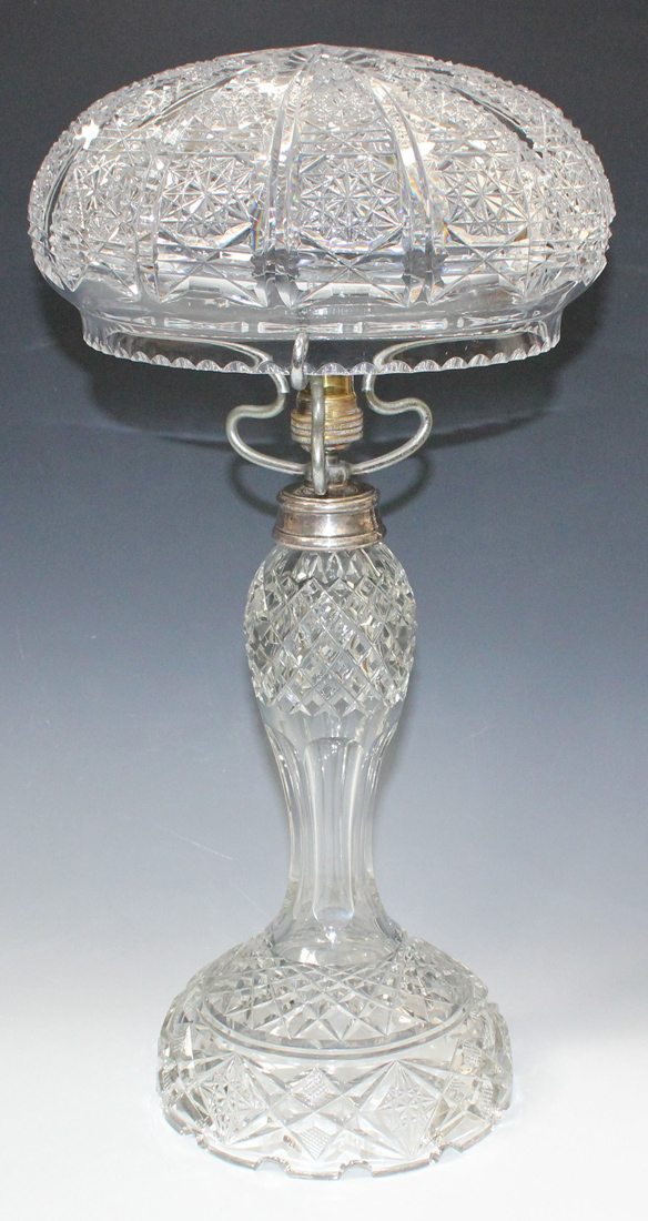 A cut glass table lamp, 20th Century, the dome top shade above a baluster stem and domed base,