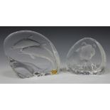 Two Mats Jonasson Swedish clear glass paperweights, one relief decorated with two leaping