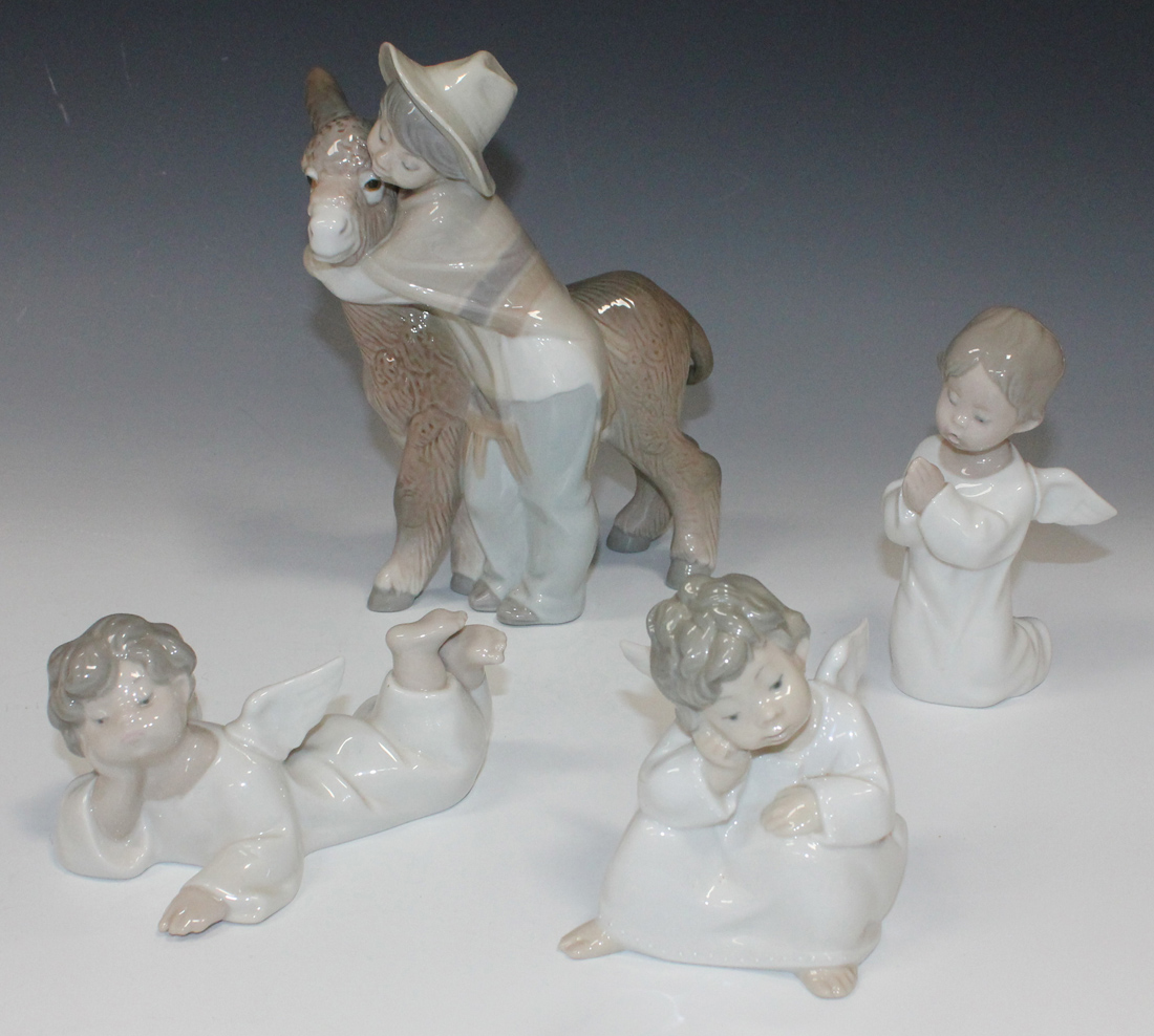 A Lladro porcelain figure Platero and Marcelino, No. 1181, boxed, and three Lladro porcelain figures