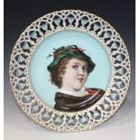 A Continental porcelain decorative plate, circa 1900, painted with a head and shoulders portrait