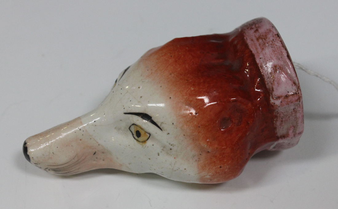 A small English fox head stirrup cup, circa 1840, naturalistically modelled and coloured with pink