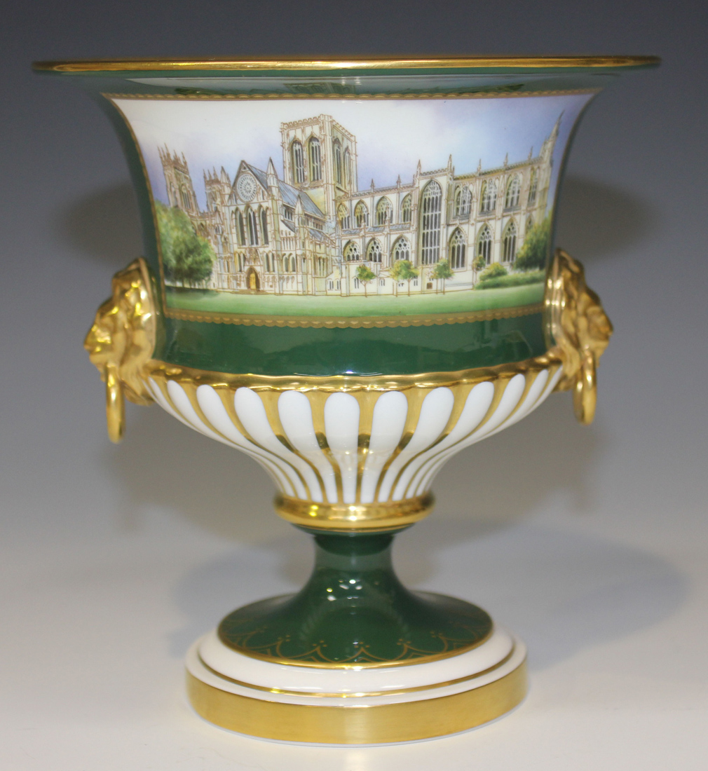 A Royal Worcester bone china urn, the body painted with a scene of 'York Minster Restored', reserved