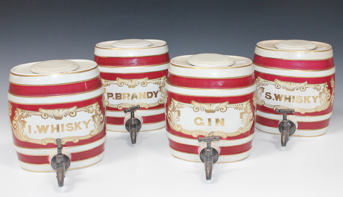 A set of four Staffordshire pottery spirit barrels with magenta and gilt banding, detailed in