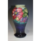 A Moorcroft Pottery Clematis pattern vase, circa 1949-86, of baluster shape with dark blue to