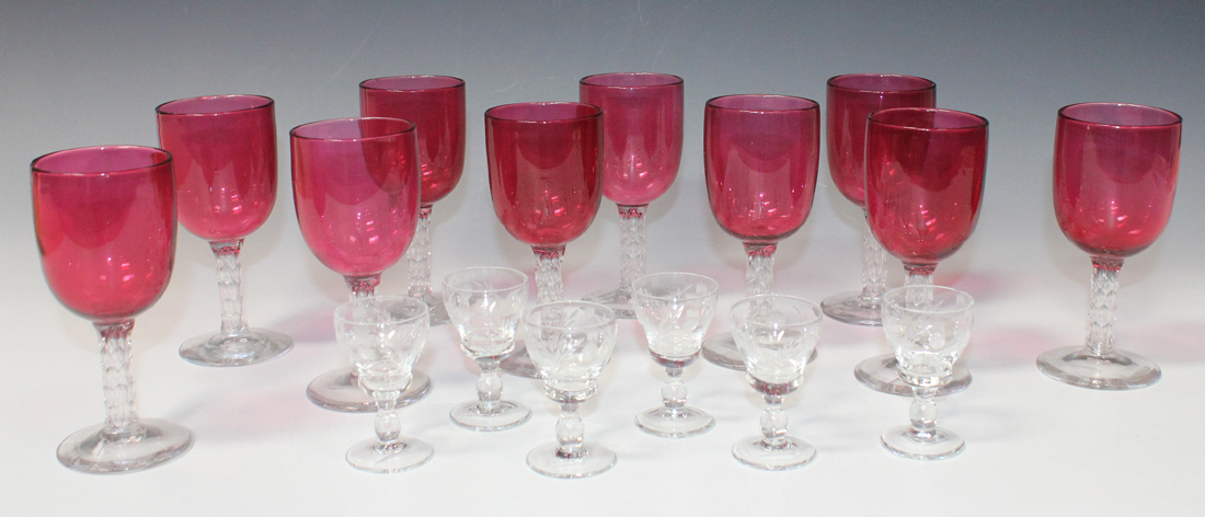A set of ten cranberry and clear glass wines, late 19th/early 20th Century, each 'U' shaped bowl