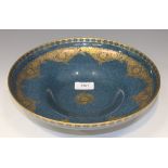 A Royal Worcester porcelain powder blue ground circular footed bowl, circa 1930, overlaid in gilt